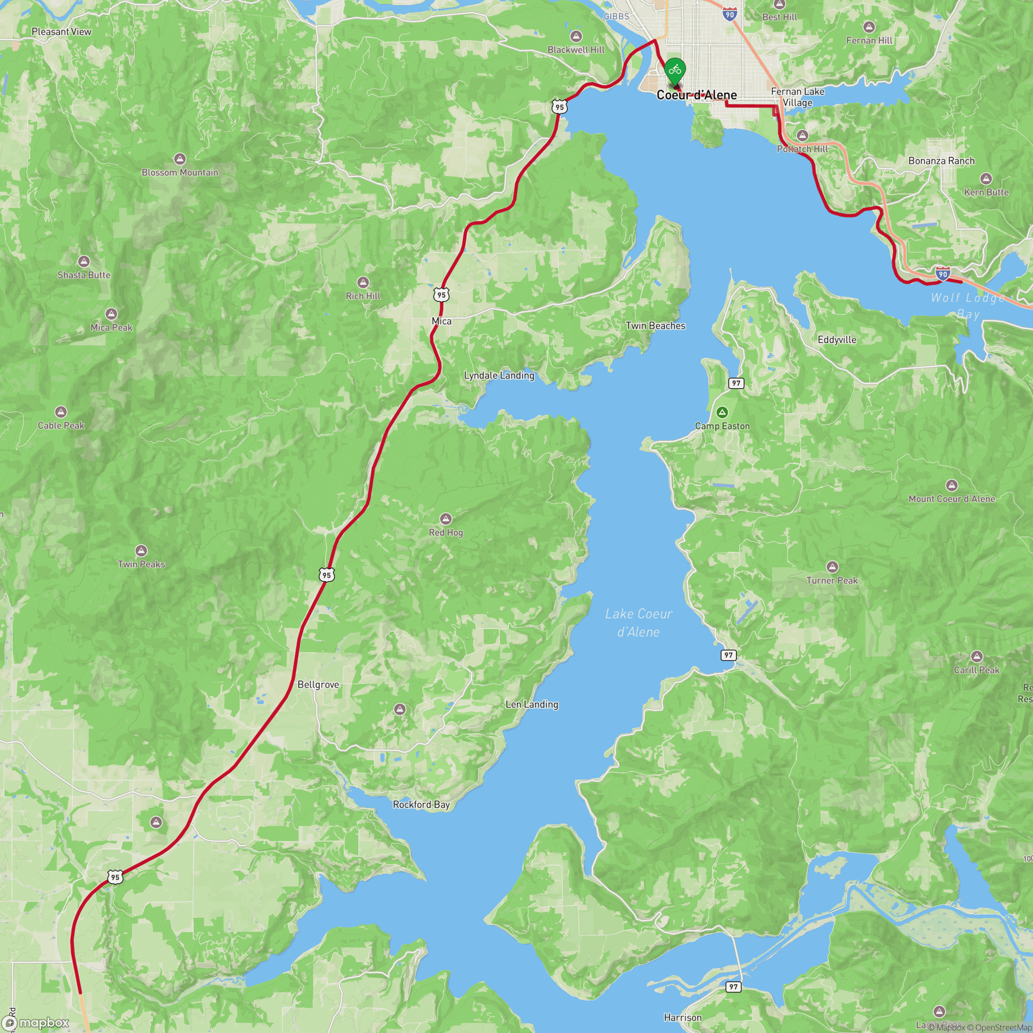 A map showing the route of the bike leg of Ironman 70.3 Coeur d'Alene, running south from Coeur d'Alene along US-95, passing through rural areas along the western shore of Lake Coeur d'Alene.