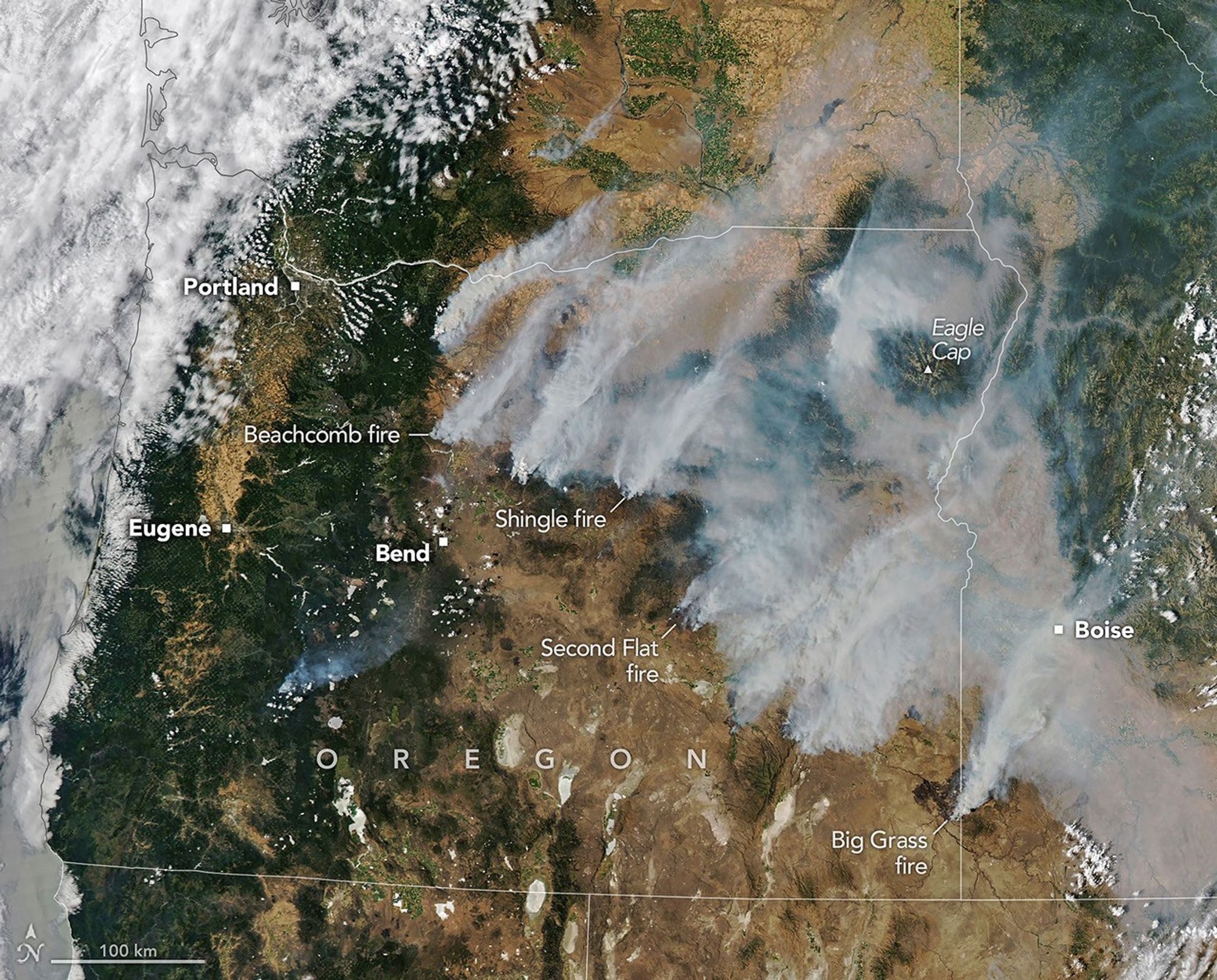 A satellite image of Oregon, showing smoke from multiple wildfires blowing to the northeast.